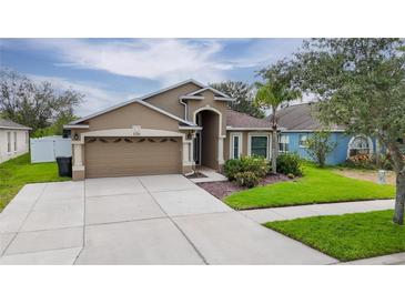 Charming single-story home featuring a well-maintained lawn and an attached two-car garage at 2330 Lawrence Hall St, Ruskin, FL 33570