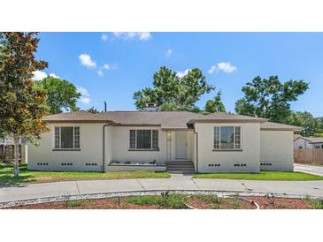 Charming single-story home with a neutral color scheme, complemented by lush landscaping and a well-manicured lawn at 2449 16Th N St, St Petersburg, FL 33704