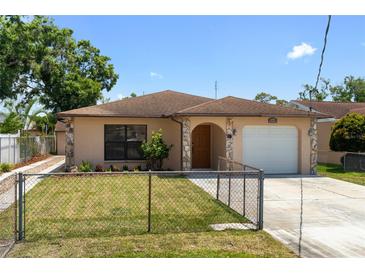 Charming single-story home with a stone facade, well-maintained lawn, and inviting curb appeal at 4208 W Flora St, Tampa, FL 33614