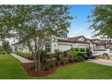 Beautiful home with a well-manicured lawn, lush landscaping, and a three-car garage at 4583 Barletta Ct, Wesley Chapel, FL 33543