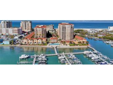 Stunning aerial view of beachfront condos, boat docks and azure waters at 521 Mandalay Ave # 307, Clearwater Beach, FL 33767