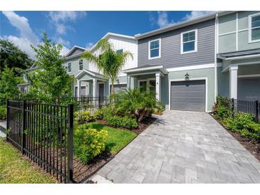 Charming townhome featuring a private garage, meticulously landscaped yard and paver driveway at 5530 N 9Th St # 6, Tampa, FL 33604