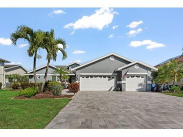 Charming single-story home with well-maintained landscaping, and a spacious driveway leading to a two-car garage at 6611 Surfside Blvd, Apollo Beach, FL 33572