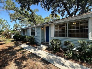 Charming single-story home with light blue siding and a well-manicured front yard at 8618 N Orangeview Ave, Tampa, FL 33617