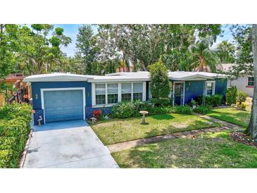 Charming blue single-Gathering home featuring a lush green lawn and well-maintained landscaping at 1115 45Th N St, St Petersburg, FL 33713