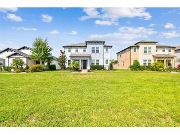 Two story home on a manicured lawn surrounded by green grass under a sunny sky at 17589 Cruiser Bnd, Land O Lakes, FL 34638