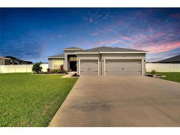 Charming single-Gathering home with a well-manicured lawn and a two-car garage at 4435 Devinshire Fields Loop, Plant City, FL 33567