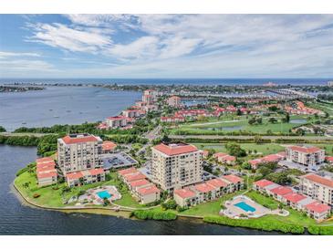 Stunning aerial view of waterfront condo community with pools, golf course, and views of the ocean at 6322 Palma Del Mar S Blvd # 1107, St Petersburg, FL 33715