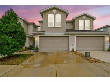 Inviting townhome featuring a spacious two-car garage and well-maintained landscaping at 1962 Marlington Way, Clearwater, FL 33763