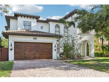 Stunning two-story home featuring a brick driveway and a beautiful arched entry at 3404 W Sevilla St, Tampa, FL 33629