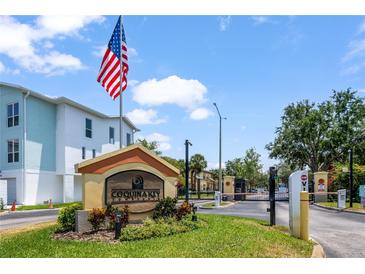 Community entrance featuring the Coquina Key sign, flag, and gate at 3866 Mariner Dr, St Petersburg, FL 33705