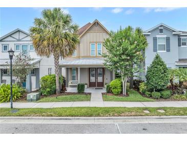 Charming two-story home featuring a covered porch with swing and manicured landscaping at 7238 Milestone Dr, Apollo Beach, FL 33572