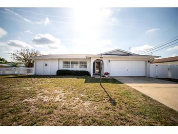 Charming single story home with an attached garage and well-maintained front lawn at 11071 141St St, Largo, FL 33774