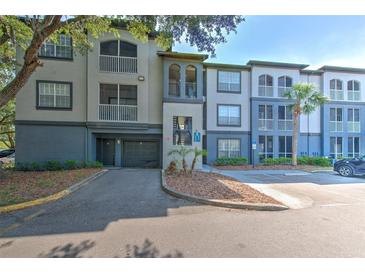 A view of the condo building featuring muted gray and blue tones, multiple stories, and balconies at 13025 Sanctuary Cove Dr # 301, Temple Terrace, FL 33637