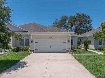 Charming one-story home featuring a manicured lawn and a two-car garage at 1528 Highland Park Dr, Clearwater, FL 33756