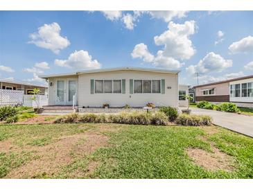 Charming home with a well-manicured lawn, complemented by bright sky, features a quaint and inviting curb appeal at 36750 Beth Ave, Zephyrhills, FL 33542