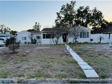 Charming single-story home featuring a well-manicured lawn and inviting walkway at 910 Robinson N Dr, St Petersburg, FL 33710