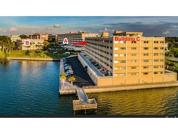 Waterfront condo building with a boat dock and stunning water views at 100 Bluff View Dr # 514C, Belleair Bluffs, FL 33770