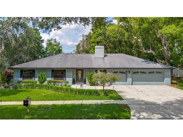 Charming single-story home with well-manicured lawn, mature trees and a two car garage at 1014 Sylvia Ln, Tampa, FL 33613