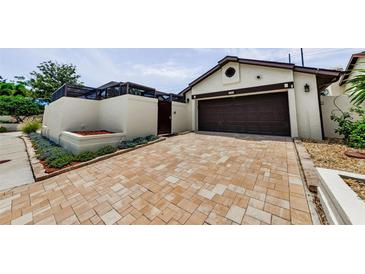 Charming single-Gathering home with a brick driveway and a two-car garage at 13544 Avista Dr, Tampa, FL 33624