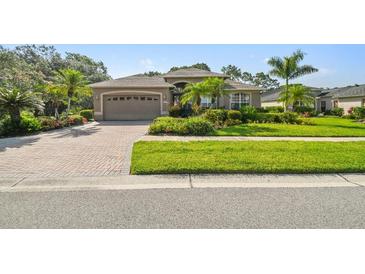 Charming single-story home featuring a brick driveway and well-manicured landscaping and lawn at 3402 Stonebridge Trl, Valrico, FL 33596
