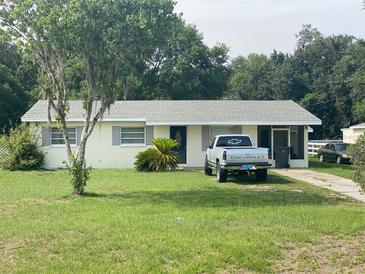 A charming single-story home features a lush front yard and a driveway with parking space for vehicles at 4316 E Knights Griffin Rd, Plant City, FL 33565