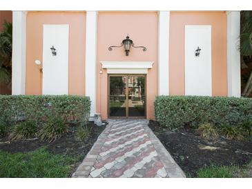 Welcoming building entrance with a classic lamp and mature landscaping at 6960 20Th N Ave # 203B, St Petersburg, FL 33710