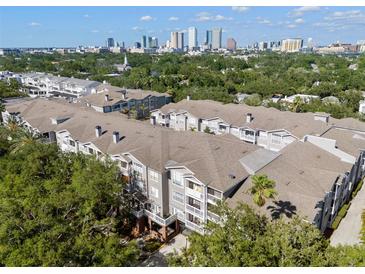 An aerial view showing the multi-story condo building and city skyline at 800 S Dakota Ave # 337, Tampa, FL 33606
