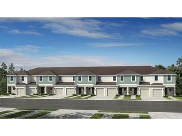 Modern townhome exterior showcases covered entries, garages, and neutral color palette at 13244 Stable Pl, Parrish, FL 34219