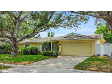 Charming single story home with mature trees, landscaped yard and two car garage at 14321 113Th Ave, Largo, FL 33774