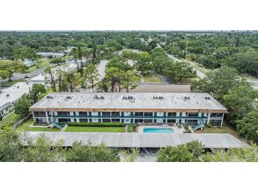 Sprawling condo community boasting a refreshing pool, lush greenery, and convenient carport parking at 1485 Lakeview Rd # 19, Clearwater, FL 33756