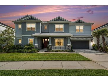 Charming two-story home featuring a well-manicured lawn, covered entry, and attached garage with an ample driveway at 33774 Castaway Loop, Wesley Chapel, FL 33543