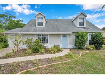 Charming home with a blue front door and landscaped front yard at 3865 Gatewood Dr, Sarasota, FL 34232