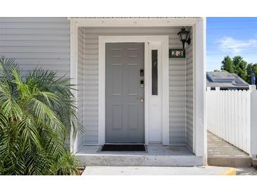 Stylish gray front door with sidelight and modern lock system provides secure and convenient access at 500 New York Ave # 23, Dunedin, FL 34698