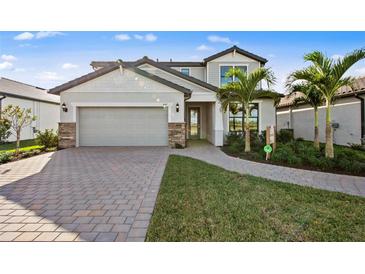 Charming two-story home featuring a two-car garage, brick-paver driveway, and well-manicured lawn at 5634 Clearwater Ct, Lakewood Ranch, FL 34211