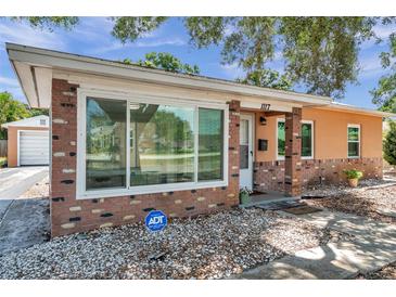 Charming single-story home with brick accents, large windows, and well-maintained landscaping at 1117 Tyrone N Blvd, St Petersburg, FL 33710