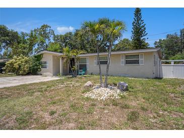 Charming single-story home features a stucco facade, well-kept landscaping and a vibrant, inviting exterior at 11486 92Nd N St, Largo, FL 33773