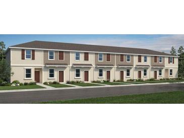 New townhouse showcases charming curb appeal with symmetrical design and neutral color palette at 14040 Textile Run, Parrish, FL 34219
