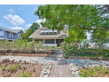 Charming home with lush landscaping and a welcoming walkway to the front porch at 1825 2Nd S St, St Petersburg, FL 33705