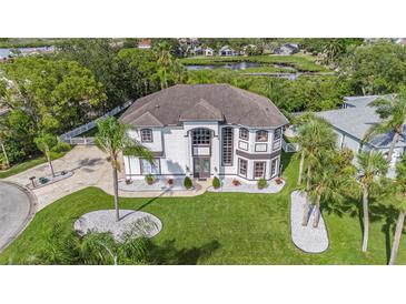 Expansive well maintained two-story home with manicured lawn and circular driveway at 4353 Dewey Dr, New Port Richey, FL 34652