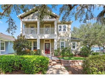 Charming two-story home featuring a inviting front porch and landscaped front yard at 5401 Match Point Pl, Lithia, FL 33547