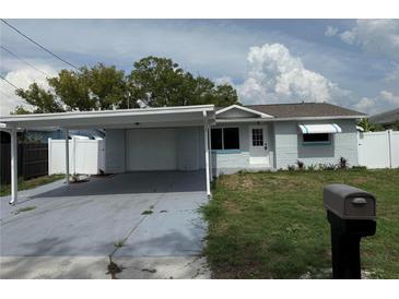 Charming single-story home featuring a carport and landscaped front yard at 13314 Lisa Dr, Hudson, FL 34667