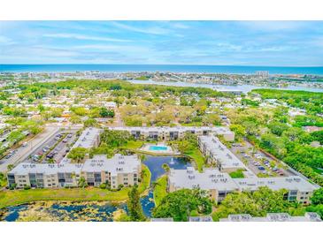 Beautifully landscaped condo community with a large pool, serene water features, and stunning ocean views at 14130 Rosemary Ln # 4115, Largo, FL 33774