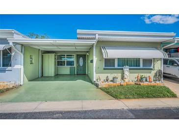 Charming single-story home with a covered parking area and a well-manicured front yard at 250 Rosery Nw Rd # 218, Largo, FL 33770