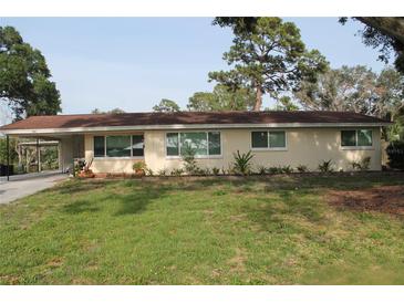 Charming one-story home featuring a carport and well-maintained landscaping at 406 2Nd Sw St, Ruskin, FL 33570