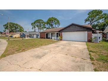 Charming single-Gathering home with an attached two-car garage and a well-manicured lawn at 4435 Sail Dr, New Port Richey, FL 34652