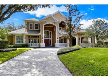 Stately home with a grand entrance, manicured lawn, and circular driveway at 704 Berrocales De Avila, Tampa, FL 33613