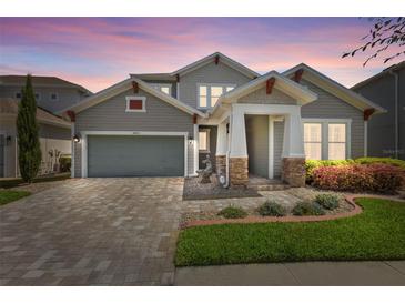 Charming two-story home featuring a well-maintained lawn, brick driveway and a two car garage at 14855 Renaissance Ave, Odessa, FL 33556