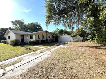 Charming single-story home featuring a detached garage and a long driveway at 403 E Carolina Ave, Plant City, FL 33563