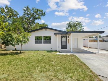 Charming single-story home featuring a covered carport, freshly painted exterior, and well-maintained landscaping at 4215 E Paris St, Tampa, FL 33610